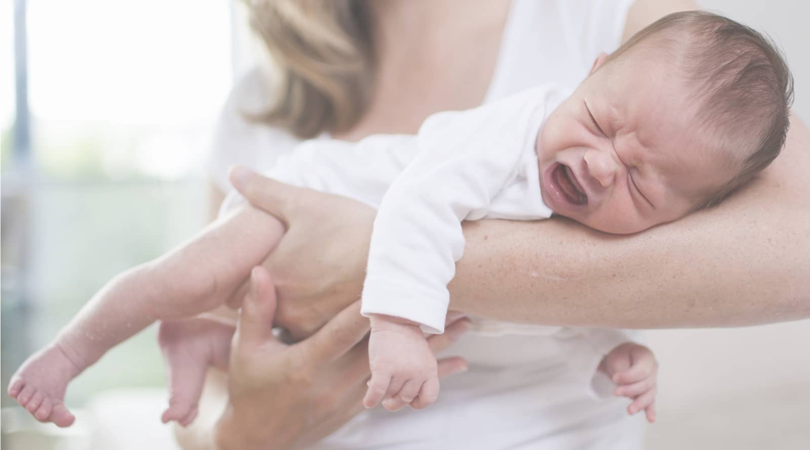 Woman holding crying baby