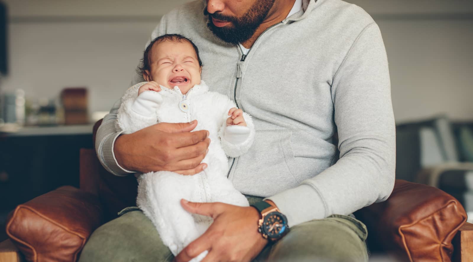 Man holding crying baby