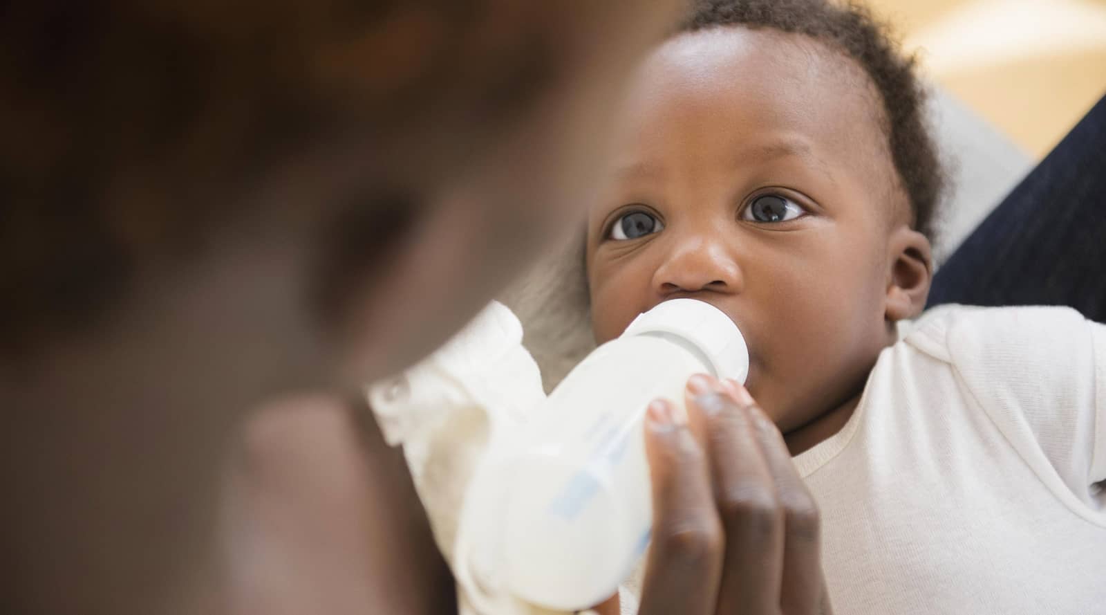 Mother bottle feeding baby