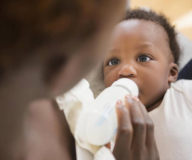 Mother bottle feeding baby