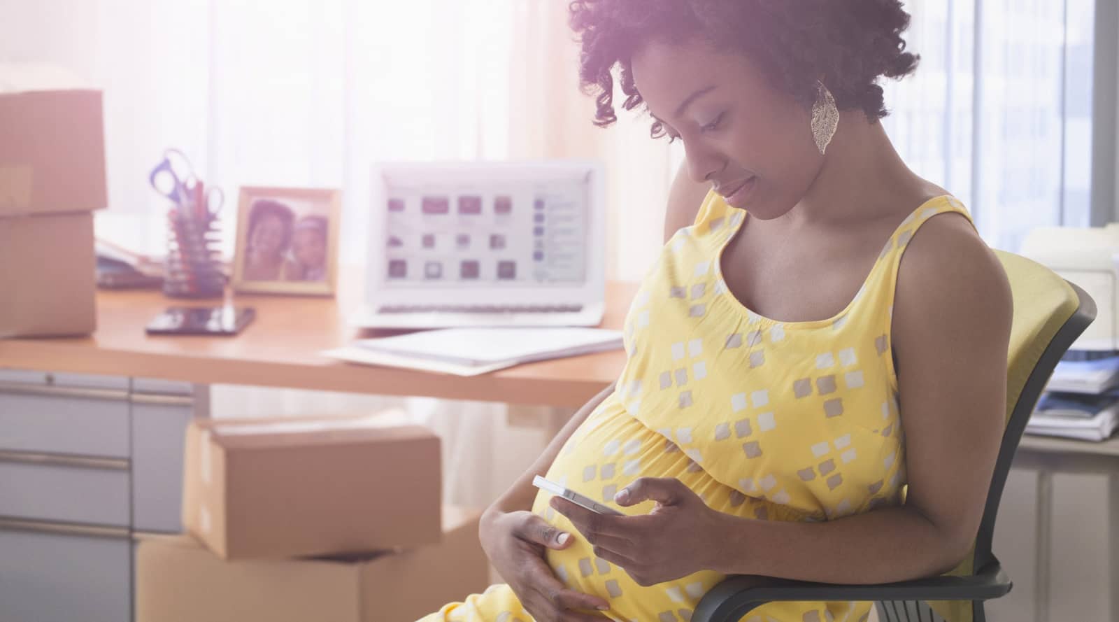 Pregnant woman looking at phone