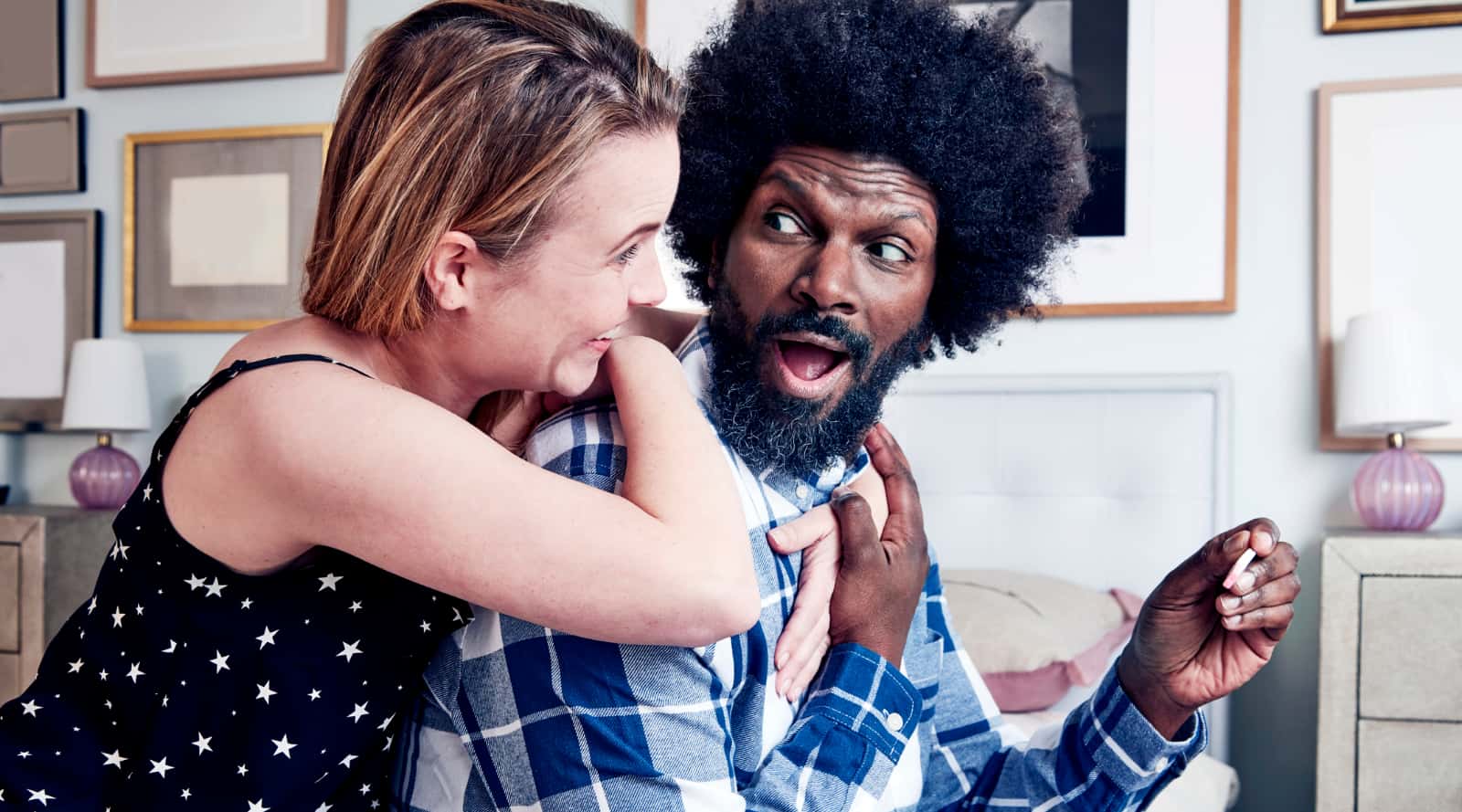 Couple reacting happily to pregnancy test