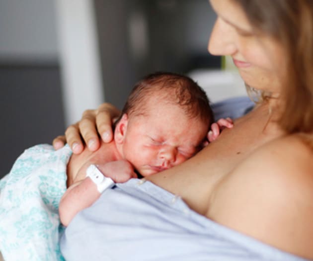 mother-holding-newborn-on-chest