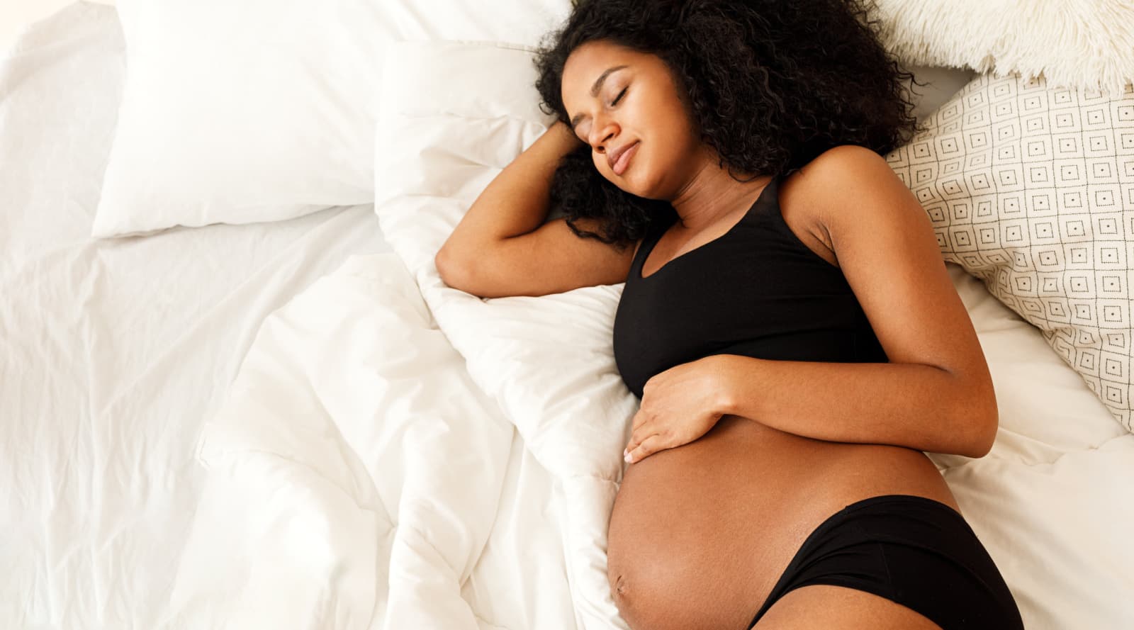 Pregnant mother sleeping in bed